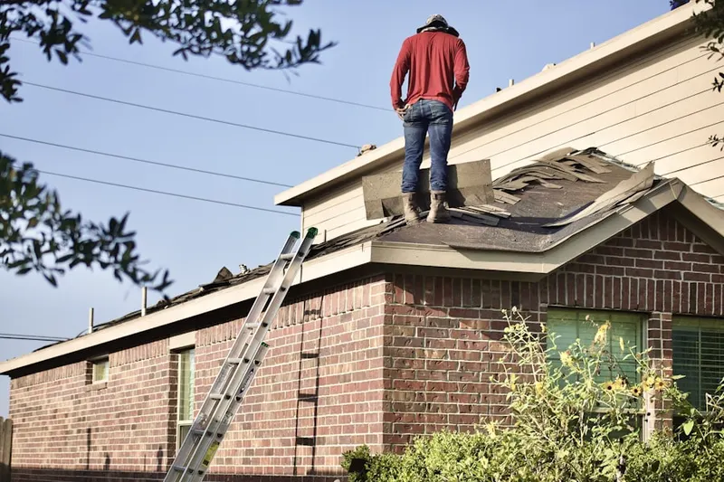 Professional roofer working on a residential roof in Downtown Columbus